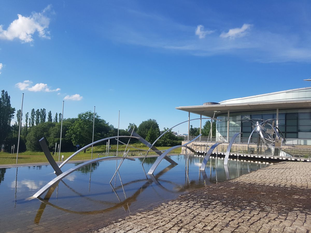 pond with steel art installation in front of a building at Technische Universität Ilmenau